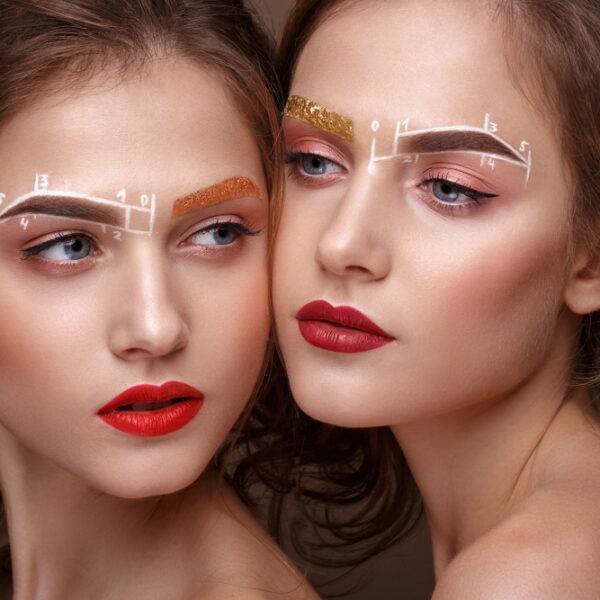 Two girls are twin sisters with an unusual eyebrow makeup.